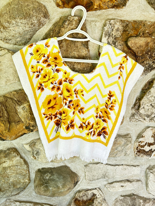 A white sleeveless top with yellow floral and a yellow chevron pattern, made from vintage beach towel